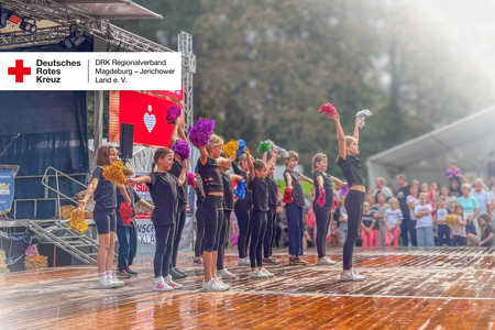 Titelbild Cheerleading-AG des DRK-Hortes „Diesterweg“ beim Kartoffelfest Kinder der Cheerleading-AG des DRK-Hortes „Diesterweg“ treten beim Kartoffelfest auf und heben ihre bunten Pompons in die Höhe.